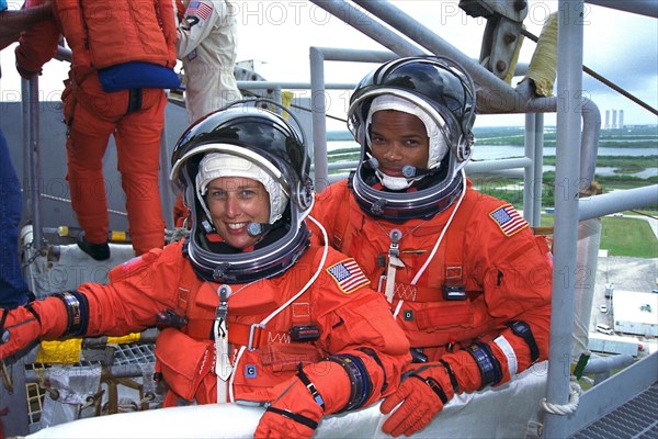 STS-85 Payload Commander N. Jan Davis (left) and Mission Specialist Robert Curbeam, Jr., check out an emergency egress slidewire basket at the 195-foot level of Launch Pad 39A during Terminal Countdown Demonstration Test (TCDT) activities ca. 1997