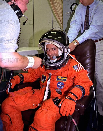 Assisted by suit technicians and others in the Operations and Checkout Building, STS-84 Mission Specialist Jean-Francois Clervoy dons his launch and entry suit during final prelaunch preparations ca. 1997