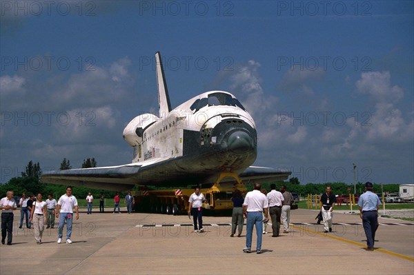 Space Shuttle Orbiter Discovery rolls over from Orbiter Processing Facility 2 on top of the orbiter transporter to the Vehicle Assembly Building for mating with its external tank and solid rocket boosters ca. 1997