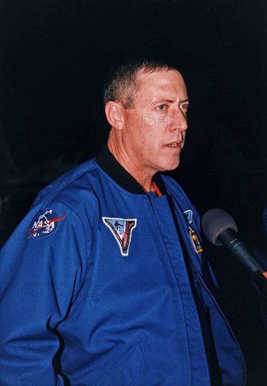 STS-81 Mission Commander Michael A. Baker talks to the press at the KSC Shuttle Landing Facility after he and his crew arrived at the space center for the final countdown preparations for the fifth Shuttle-Mir docking mission ca. 1997