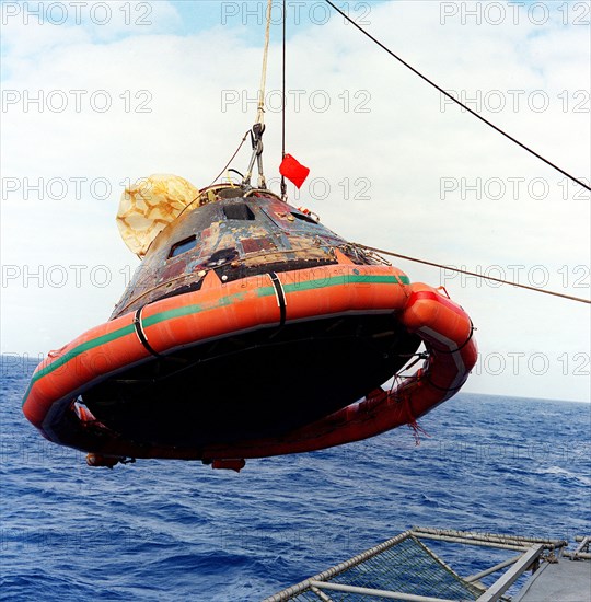 24 July 1969) --- The Apollo 11 Command Module (CM) is photographed as it is hoisted aboard the USS Hornet, prime recovery vessel for the historic Apollo 11 lunar landing mission.