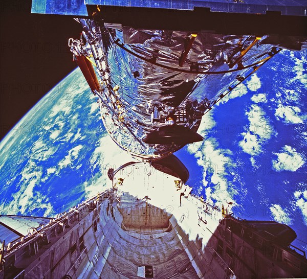 In this photograph, the Hubble Space Telescope (HST) is clearing the cargo bay during its deployment on April 25, 1990. The photograph was taken by the IMAX Cargo Bay Camera (ICBC) mounted in a container on the port side of the Space Shuttle orbiter Disco