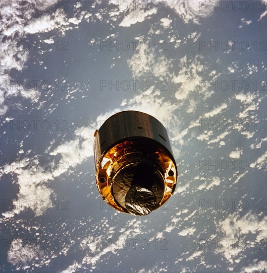 1992 - The 4.5 ton satellite was successfully snared by three astronauts on a third EVA. The three hand-grabbed the errant satellite, pulled it into the cargo bay, and attached a boost-given perigee stage before its release. In this photo, the satellite s