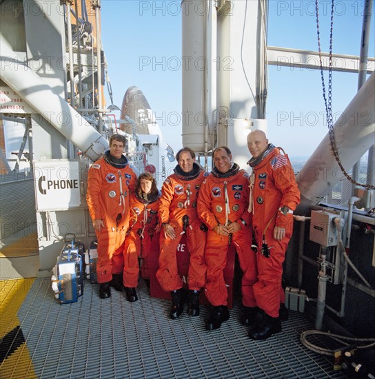 1990 - STS-33 crewmembers on KSC LC Pad 39B 195 ft level with OV-103 in background