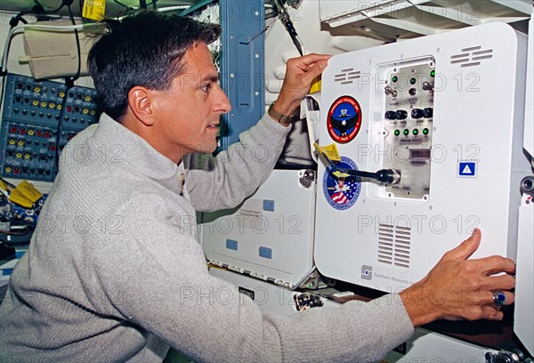 Thomas checks the condition of the MIS-B middeck locker experiment