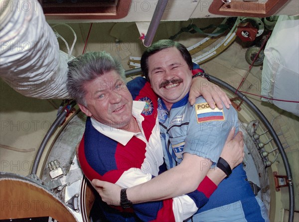 STS-91 crew is greeted at the hatch by Mir 25 crewmembers