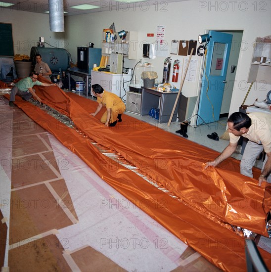 (18 May 1973) --- Workmen in the GE Building across the street from the Johnson Space Center fold a sail-like sunshade being fabricated for possible use as a sunscreen for the Skylab Orbital Workshop (OWS).