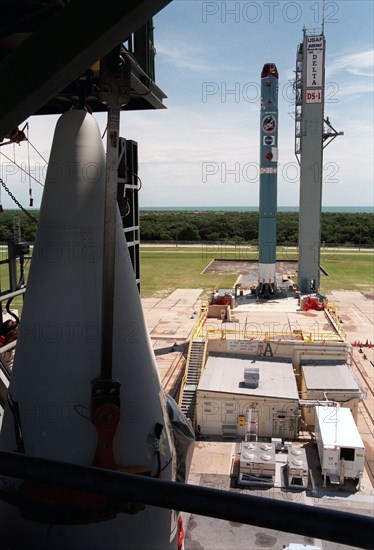 1998 - (Left) A solid rocket booster is lifted for installation onto the Boeing Delta 7326 rocket that will launch Deep Space 1 at Launch Pad 17A, Cape Canaveral Air Station.