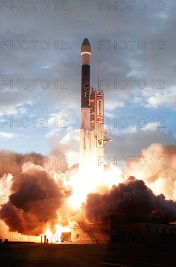 1998 - Lighting up the launch pad, a Boeing Delta II (7326) rocket propels Deep Space 1 through the morning clouds after liftoff from Launch Complex 17A, Cape Canaveral Air Station.