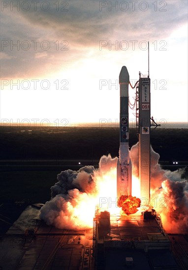 1998 - Lighting up the launch pad below, a Boeing Delta II (7326) rocket is silhouetted in the morning light as it propels Deep Space 1 into the sky after liftoff from Launch Complex 17A, Cape Canaveral Air Station.