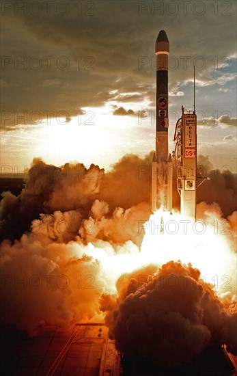 1998 - A Boeing Delta II (7326) rocket lights up the clouds of exhaust below as it propels Deep Space 1 into the sky after liftoff from Launch Complex 17A, Cape Canaveral Air Station.