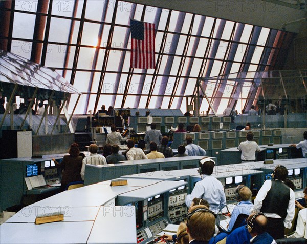 1990 - At the conclusion of another successful countdown, members of the KSC launch team in Firing Room 1 rivet their eyes on the skies to the east of the Launch Control Center. Their reward was a glimpse of Columbia burning its way upward up from Complex