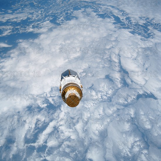 STS-43 TDRS-E & IUS over the Pacific Ocean after deployment from OV-104's PLB