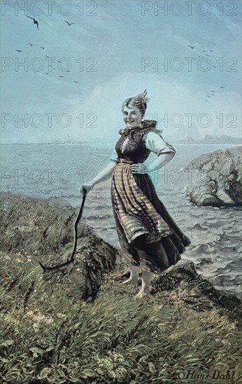 Eine Bauersfrau beim Mähen an der Küste der Nordsee