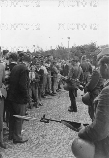 Heavily armed troops of the East German police patrol