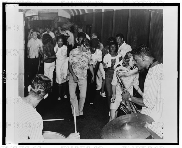 Young people dancing at a party, doing the Twist