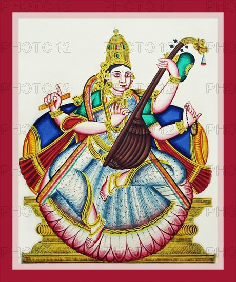 Sarasvati sits in lalitasana on a lotus flower