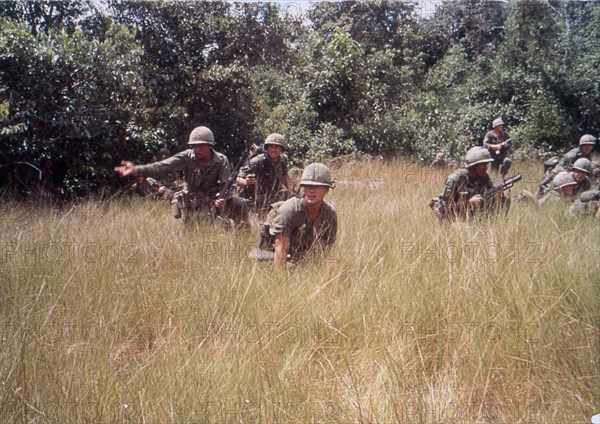 US 14th Infantry Division draws Viet Cong sniper fire while on a search mission. Vietnam, 1965.