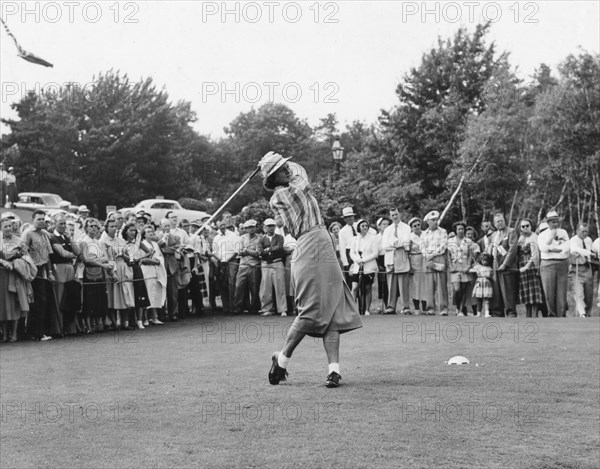 Babe Didrickson Zaharias drives the ball from the 10th tee in the first round of the Women's National Open Gold Championship. Peabody, MA, 7/1/54.