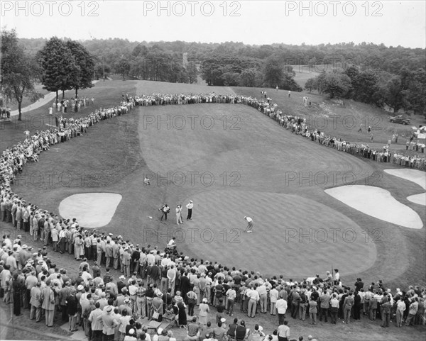 Crowd gathered around the 18th green at the Wykagyl Country Club to watch Bobby Locke of South Africa at the Palm Beach round-robin tournament. New Rochelle, NY, 6/8/51.