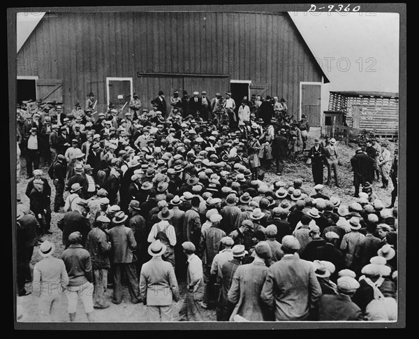 Inflation. Aftermath of inflation--a foreclosure tale in Iowa in the early 1930s when "the bottom fell out of everything." Military police were on hand to keep farmers from preventing the auction, Iowa, circa 1931.