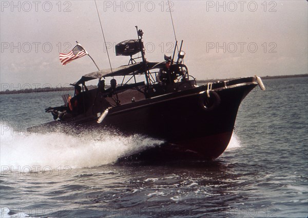 USN River Patrol Boat cruises in an inlet in search of craft carrying supplies to Viet Cong. Vietnam, June 22, 1966.