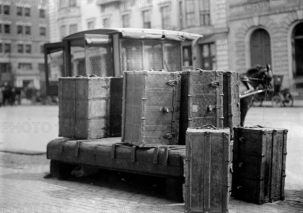 Packing trunks sitting on the side of a city street ca. 1909-1914