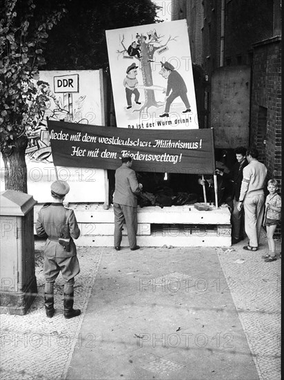 9/21/1961 - Banner Says: 'Down With West German Militarism! Give Us A Peace Treaty!' Residents of East Berlin Houses Living Near the Border Wall are Being Evacuated