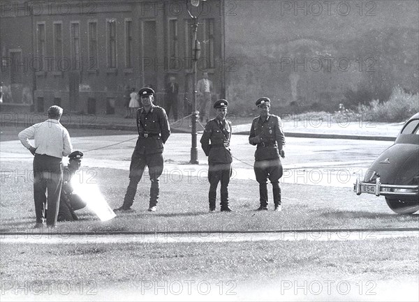 9/24/1961 - While Occupants of Bernauer Strasse Are Being Forcefully Evacuated from Their Apartments the Volkspolizei is Holding Up Mirrors to Blind Reporters and Cameramen from the West. Sept. 24, 1961