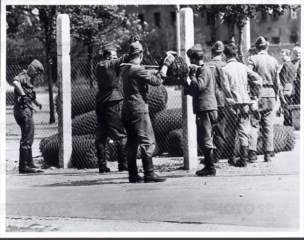 Communist Troops String Barbed Wire Along Top of Newly Constructed Border Fence Designed to Shut East Berlin Off from Western Contact