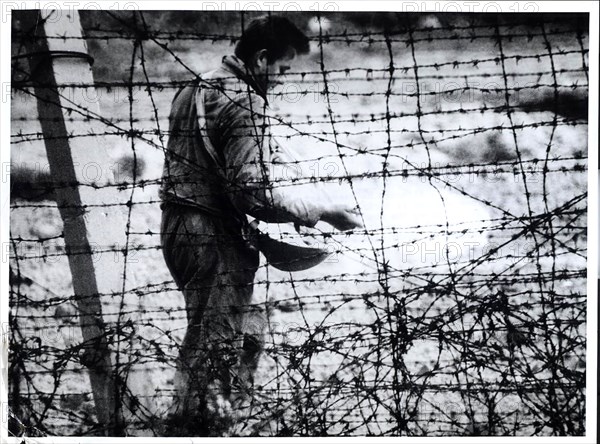 'Death Strip' Although He Resembles A Farmer Sowing Seed, This East German Workman Is Sprinkling Chemicals to Kill Weeds in the 'Death Strip' Along The Communist Built Wall In East Berlin