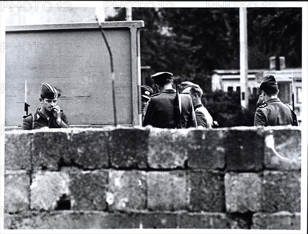 August 1961 - East German Troops and Police Group Together Behind The Wall Built By The Communists to Seal Off East Berlin From The Western Part of the City