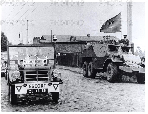 The Dividing Line Actually Runs Between The Two Vehicles. In the Right Background Is Part of the Fence Built By the Communists to Isolate the East Sector. The 'FDJ' On The Flag Stands for 'Freie Deutsche Jugend' The 'Free German Youth', Who Are Supposed to Be Manning The Armored Car