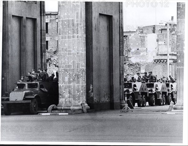 August 1961 - A Column of East German Armored Cars Lines Up Behind Brandenburg Gate Against Background of War-Scarred Buildings of East Berlin