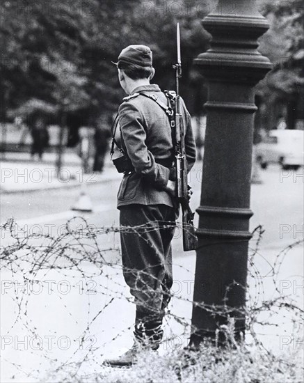 August 1961 - Standing Like A Forlorn Symbol of Repression, This Teen-Aged East German Soldier Stand Guard By The Closed Border