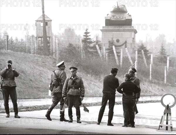 Berlin, April 1965 - East German Communist Guards Stop Traffic at Autobahn at Wannsee Near Berlin. Communist War Memorial in the Background