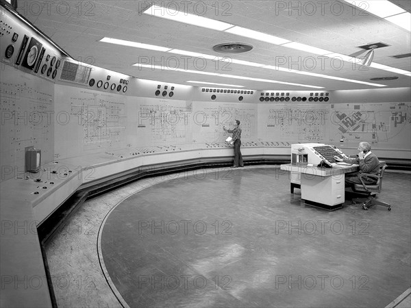 Operators in the Engine Research Building’s Central Control Room at the National Aeronautics and Space Administration (NASA) Lewis Research Center. The massive 4.25-acre Engine Research Building contains dozens of test cells, test stands, and altitude chambers. A powerful a collection of compressors and exhausters located in the central portion of the basement provides process air and exhaust for these test areas. This system is connected to similar process air systems in the laboratory’s other large test facilities. The Central Control Room coordinates this activity and communicates with the local utilities.