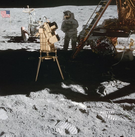 Apollo 16 Astronaut stands in the shadow of the Lunar Module (LM)