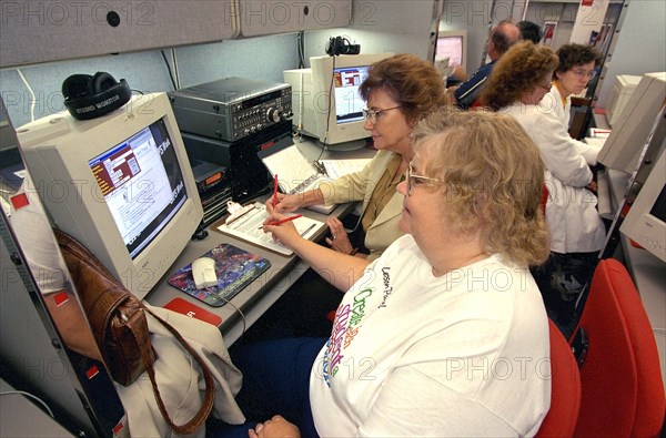 Teacher workship in late 1990s with teachers working on 20th century computers.