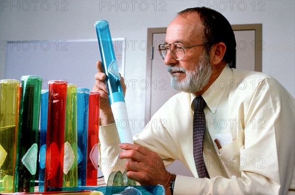 Scientist examining beakers ca. 1996