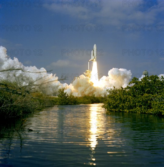 (12 Nov. 1981) --- Framed here by Florida vegetation, the 37-meter-tall (122 feet) NASA space shuttle Columbia lifts off from Launch Pad 39A at NASA-Kennedy Space Center (KSC). Astronauts Joe H. Engle and Richard H. Truly begin the second space shuttle (STS-2) flight.