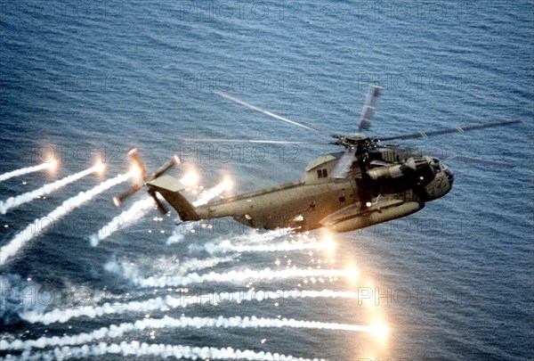 An air-to-air right side view of a CH-53D Sea Stallion helicopter