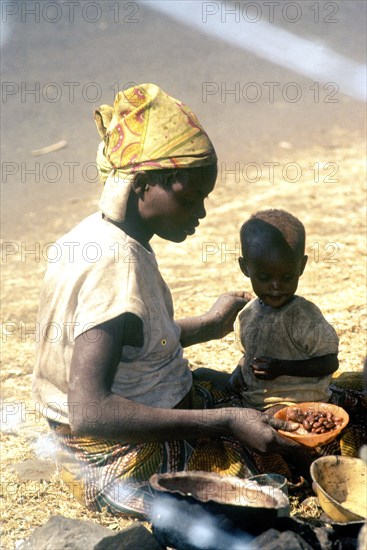 A Rwandan mother feeds her child.  Rwandan refugees entered Goma