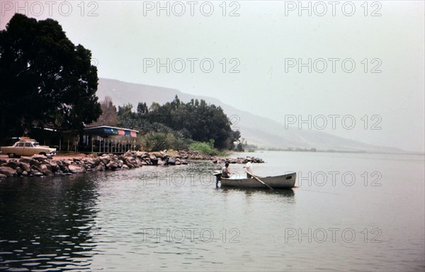 Two men rowing a boat in Lake Gailee in Israel