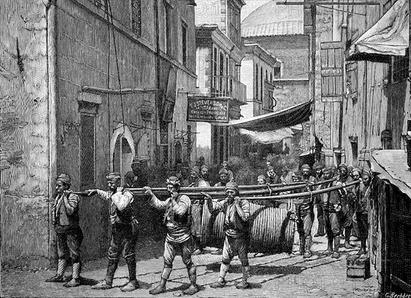 Load Carriers In Armenia Carry A Large Pulley With Wire Rope
