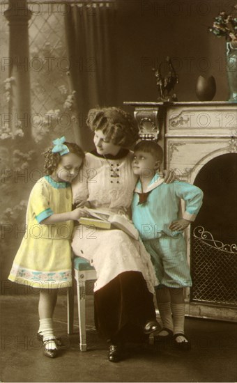 Mother and Children Read Together.