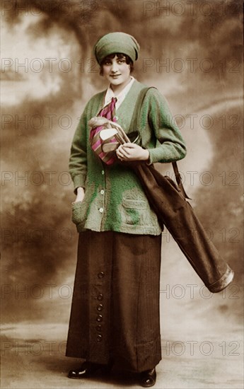 Woman golfer with golf club bag.