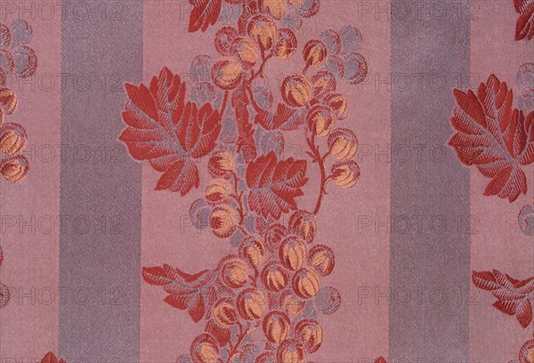 Woven silk pattern of red leaves and berries.