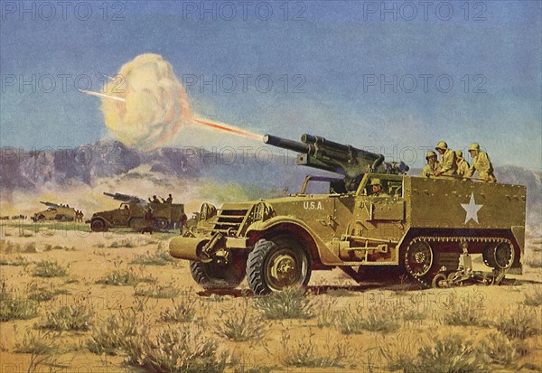 Truck tank shooting artillary gun in the field.