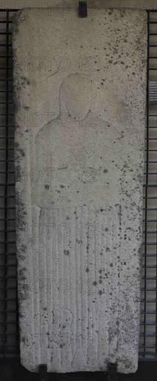 Tombstone with bas-relief depicting a woman wearing the Franciscan habit